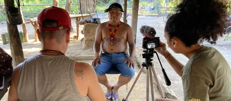 I giornalisti di The Intercept conducono la video-intervista con il leader indigeno Itahu Ka'apor. Due giornalisti di The Intercept di spalle durante l'intervista video con il leader indigeno Itahu Ka'apor, che si trova di fronte.